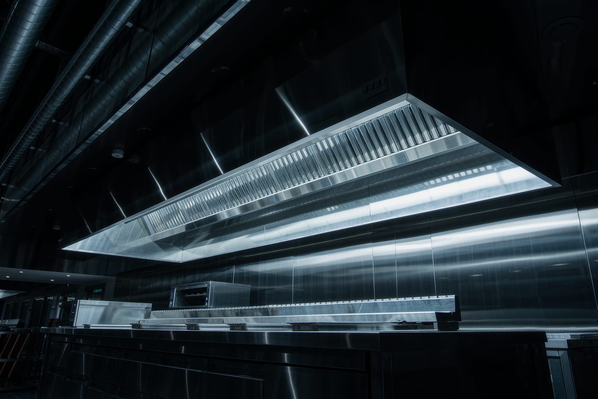 Commercial kitchen hood connected to code-compliant grease duct